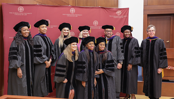 Graduates pose with Dean Utset
