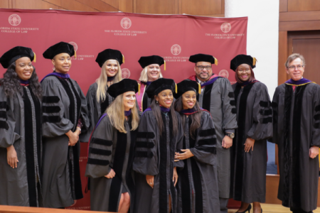 Graduates pose with Dean Utset